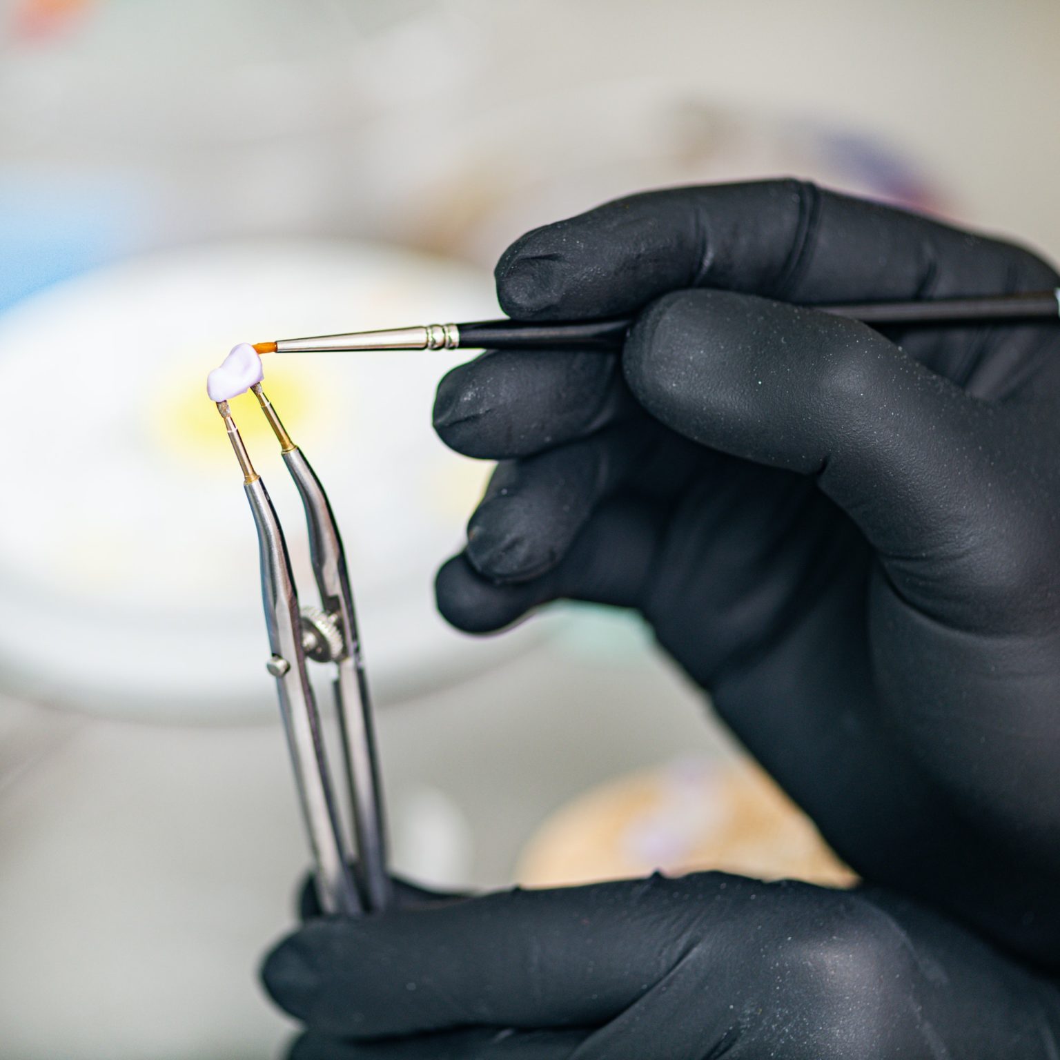 Dental Technician Preparing Ceramic Tooth Crown. Prosthetic Dentistry.