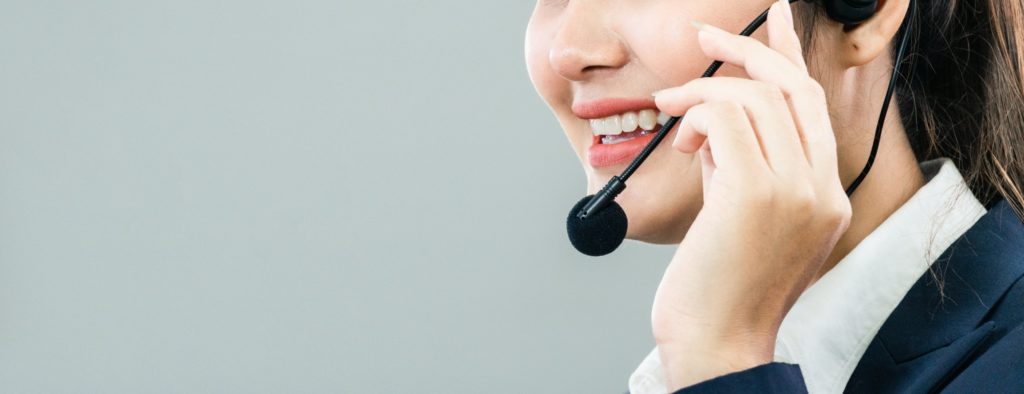 Female call center talking with customer at desk