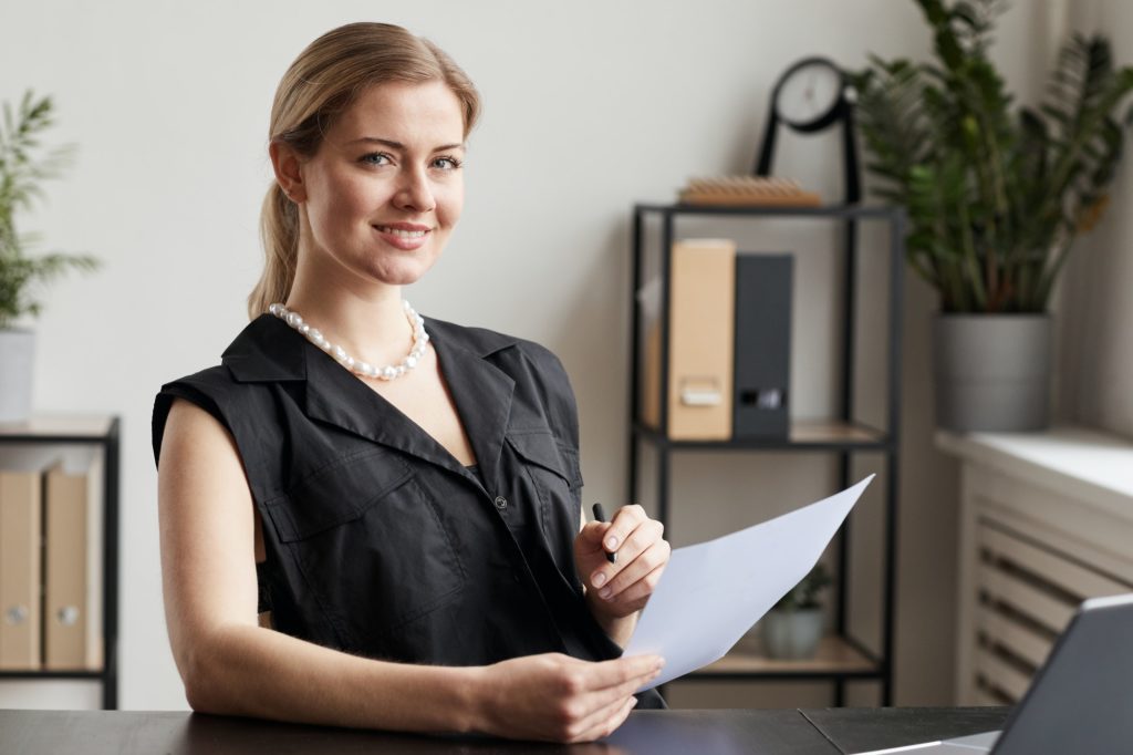 successful woman smiling at desk