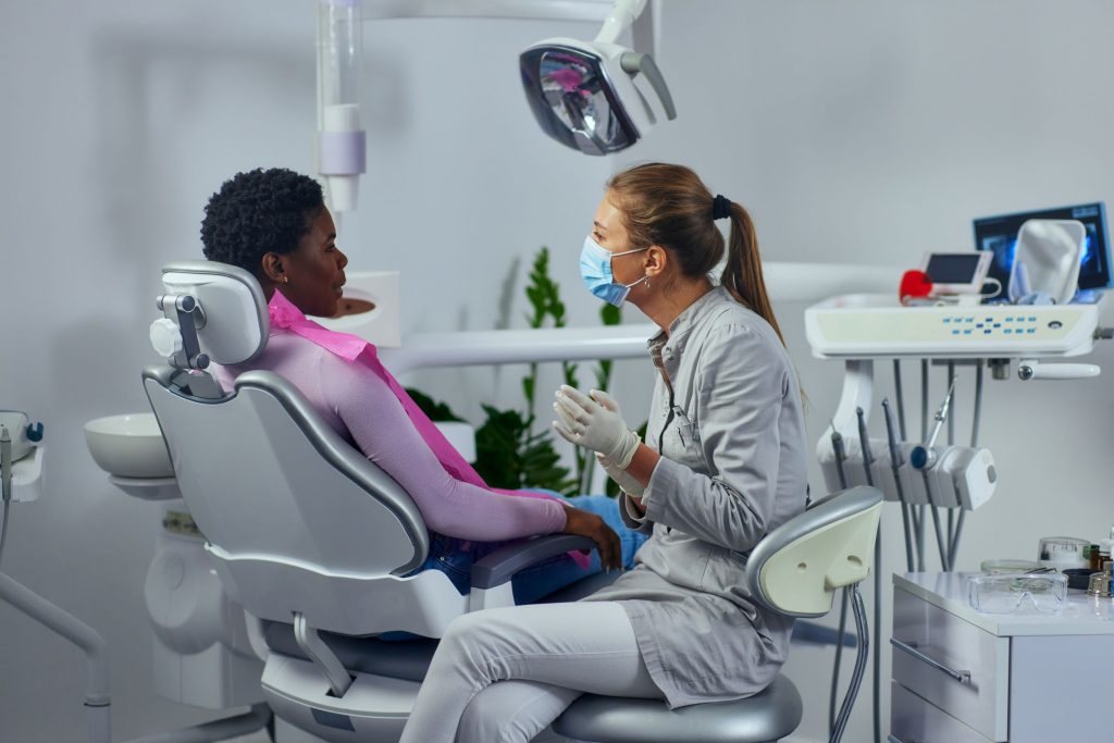 Dentist talking to his patient